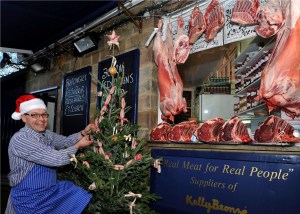 Santa, erm, I mean Nick Allen, decorating the Meat Christmas Tree with garlands of chipolata sausage, streaky bacon tinsel, baubles of traditional faggots and black pudding rings and topped with streaky bacon star.